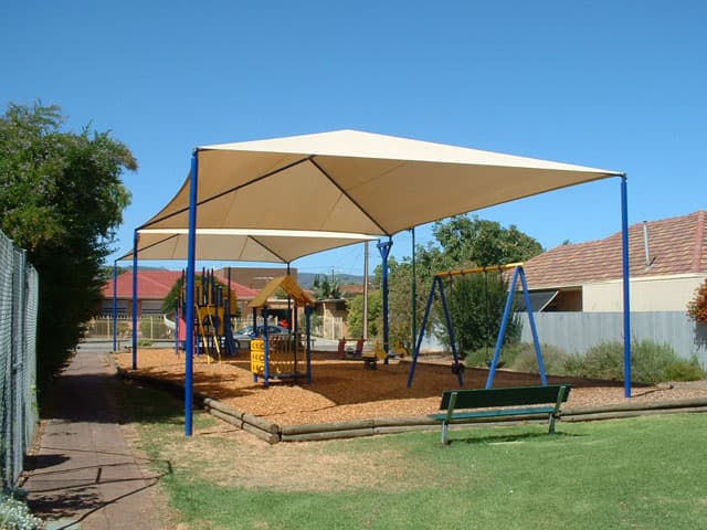 A shade structure covering a playground